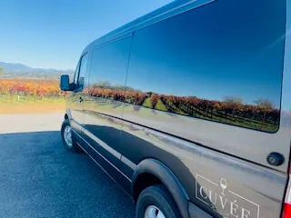Autumn vineyards reflected in the dark side of a Cuvée Sprinter van